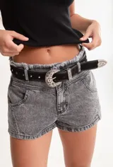 Cinto negro de cuero con hebilla plateada estilo western y apliques de tachas plateadas.