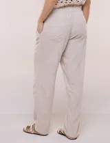 Pantalón de lino blanco, marca Dash, con pretina ancha elastizada, lazo de ajuste y bolsillos inclinados en el frente.