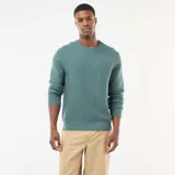 Sweater de punto fino con cuello redondo, manga larga y puños acanalados, de diseño liso y corte estándar.