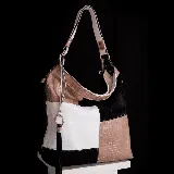 Bolso hobo con diseño patchwork en cuero vacuno color negro, blanco, rosa y marrón. Tiene correa de mano y correa bandolera ajustable.
