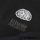 Campera negra con cuello camisero, cierre frontal con cremallera, bolsillos laterales con botón y logo bordado en el pecho.