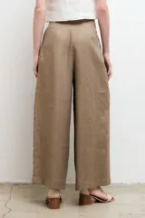 Pantalón blanco de lino, de corte palazzo, tiro alto y pierna ancha.