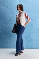 Jean de tiro alto con corte recto, confeccionado en denim con spandex. Presenta un lavado gris oscuro con efecto desgastado, cierre frontal con botón y bolsillos laterales y traseros.