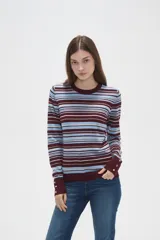 Remera de manga larga confeccionada en viscosa, con diseño de rayas horizontales en tonos rosados, blancos y marrones. Presenta un corte ajustado al cuerpo y cuello redondo a la base.