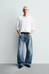 Camiseta de manga larga color gris jaspeado, corte regular fit y cuello redondo con acabado en rib.