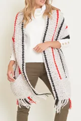 Pashmina tejida a mano en crochet, con diseño de rayas verticales en color crema y marrón. Presenta terminaciones con flecos en el ruedo y una textura acanalada distintiva.