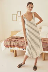 Vestido midi color crema con rayas horizontales negras, escote en V y tirantes con lazos.