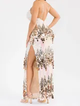 Vestido largo y elastizado íntegramente bordado con lentejuelas grandes en tonos beige, rosa y dorado. Presenta escote en V con aplique de tul transparente, breteles finos regulables, espalda semidescubierta y tajo lateral en la falda.