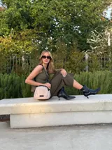 Bandolera pequeña de diseño moderno, confeccionada en tafeta liviana y resistente. Cuenta con cierre superior, correa ancha ajustable y logo frontal de la marca.