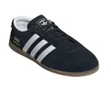 Championes Adidas modelo Gazelle Lo Pro, color negro con las icónicas tres tiras laterales en blanco. Presenta un diseño de perfil bajo con capellada de gamuza, interior en contraste blanco y suela de goma color caramelo. Incluye el logo de la marca y el nombre del modelo en dorado en el lateral.