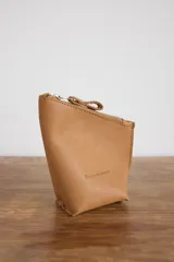 Yerbera de cuero tostado, con cierre metálico superior y diseño estructurado.