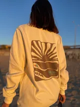 Buzo color crema de algodón con cuello redondo y mangas largas. Estampado en el frente con líneas horizontales de colores y una línea ondulada que simula un electrocardiograma.