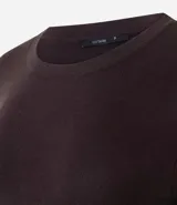 Suéter de punto ajustado con cuello redondo y manga larga. Presenta detalle de botones metalizados en los puños.