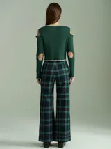 Saco de punto acanalado color bordó con detalles en color crudo en el cuello, plaqueta de botones y ruedo. Presenta aberturas en los hombros y cierre frontal con botones pequeños.