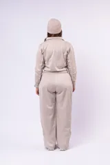 Pantalón deportivo de corte recto y tiro alto, color beige, con cintura elástica y franjas laterales sutiles.