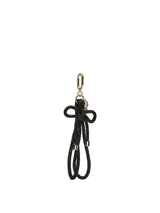 Llavero con correa de muñeca de textura brillante en color negro, adornado con un nudo y herrajes metálicos dorados.