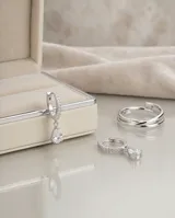 Aros de plata 925 con diseño de argolla pequeña decorada con circonias y dije colgante en forma de gota.