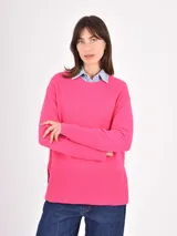 Buzo de tejido de punto color negro, con cuello redondo, mangas largas y puños anchos acanalados. Presenta un diseño con ruedo asimétrico y aberturas laterales.