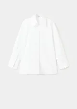 Camisa blanca de corte oversize y diseño largo, confeccionada en algodón. Presenta cuello camisero, cierre frontal con botones, mangas largas con puños abotonados y un distintivo diseño de espalda cruzada.