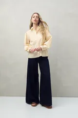 Camisa blanca de mangas 3/4 abullonadas con bordado floral en el frente.