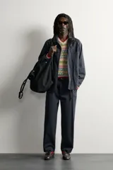 Sobrecamisa de algodón de corte relajado, color negro con efecto gastado, cuello con solapas de muesca, mangas largas raglán y cierre frontal con botones. Cuenta con bolsillos frontales de plastrón en el pecho y en la parte inferior.