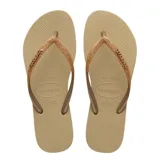 Sandalias tipo ojota Havaianas modelo Slim Glitter II, color beige arena. Presentan tiras finas con acabado de glitter brillante y logo de la marca en relieve.