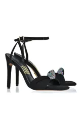 Sandalia de tacón alto color amarillo con pulsera al tobillo y detalle de moño con strass en la capellada.