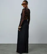 Vestido midi de encaje negro con diseño de transparencia, corte recto, cuello redondo y mangas largas.