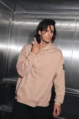 Buzo oversize color nude confeccionado en frisa, con capucha amplia, bolsillo canguro, terminaciones de puño y ruedo con rib, y logo de la marca bordado en el centro delantero.