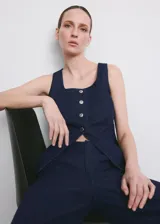 Top de denim color azul oscuro, con escote cuadrado, sin mangas y cierre frontal con botones.