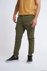 Pantalón cargo de corte slim, color verde militar, con cierre y botón frontal, bolsillos laterales tipo cargo y sin puños en los tobillos.