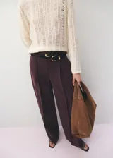 Pantalón wide leg de tiro bajo, color bordó, con bolsillos laterales y trabillas para cinturón.
