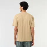Camiseta lisa de corte oversize y cuello redondo en color beige.