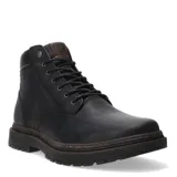 Bota de cuero color negro con cordones, diseño de caña media y suela de goma con relieve antideslizante. Presenta detalle de parche de cuero marrón en la lengüeta con logo grabado.