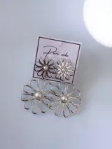 Aros colgantes plateados en forma de flor con perla en el centro, compuestos por dos margaritas unidas en cascada.