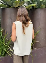 Chaleco tejido de punto color ladrillo, con escote en V y terminaciones desflecadas.