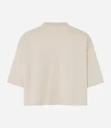 Remera cropped de manga corta, cuello redondo y calce oversized, confeccionada en tejido de algodón tipo media malla.