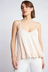 Musculosa de breteles finos con diseño de espalda nadadora y detalle de volados en el ruedo.