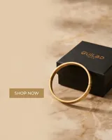 Esclava rígida de acero con baño de oro y diseño grabado de guarda griega.