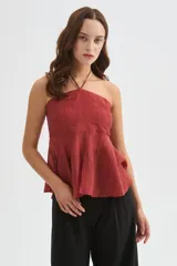 Top halter color amarillo claro, con escote strapless y detalle de argolla en el cuello, confeccionado en viscosa con diseño holgado y acabado fluido.