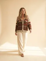 Cardigan de punto con diseño fair isle en tonos chocolate, ladrillo, naranja quemado y crema, de manga larga y escote en V.