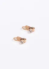 Par de caravanas doradas con forma ovalada y clip, con strass incrustado.