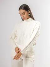 Sweater de tejido de punto con cuello alto y diseño de trenzas verticales en el frente y las mangas. Presenta puños y ruedo acanalados.