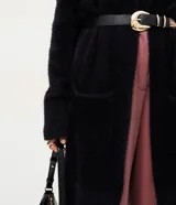 Cardigan largo de punto con textura de pelos, color negro, con mangas largas y bolsillos frontales. Diseño abierto y versátil de la marca Cortelle.