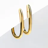 Par de aros dorados grandes, que simulan argollas. Con pasante y fru fru. De diseño ovalado, inflado y liso.