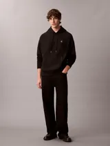 Buzo con capucha negro Calvin Klein, de felpa suave, con cordones ajustables, bolsillo tipo canguro y pequeño monograma bordado en el pecho.