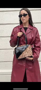 Cartera rígida negra con diseño artesanal, combinada con cuero color visón con textura y tachas plateadas. Tiene herrajes y cierre metálico plateado marca YKK, asa fina para llevar al hombro o en la mano y correa larga extra regulable.