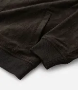 Campera bomber azul marino de pana con cuello redondo, cierre con botones a presión, bolsillos laterales y puños y cintura elastizados.