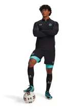 Campera deportiva de entrenamiento con cierre frontal de un cuarto, color negro con detalles en turquesa. Presenta mangas largas con orificios para pulgares, paneles de jacquard y logos de Under Armour y Mansory en el pecho.
