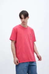 Remera celeste de algodón con bolsillo en el pecho, teñida en prenda. Tiene una etiqueta en el bolsillo y un estampado en la espalda.